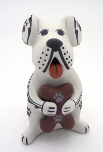 Dog storyteller holding bone by Jemez potter Darrick Tsosie