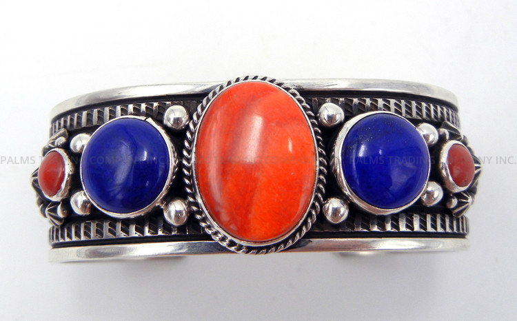 Navajo multi-stone and sterling silver cuff bracelet featuring orange spiny oyster, lapis, and coral