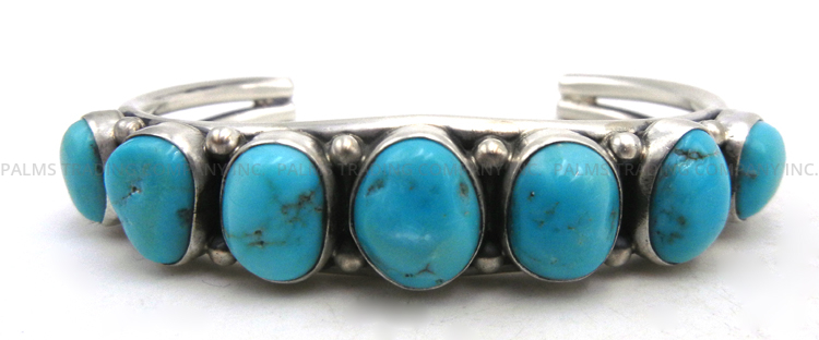 Navajo seven stone turquoise and sterling silver row cuff bracelet by Nila Johnson
